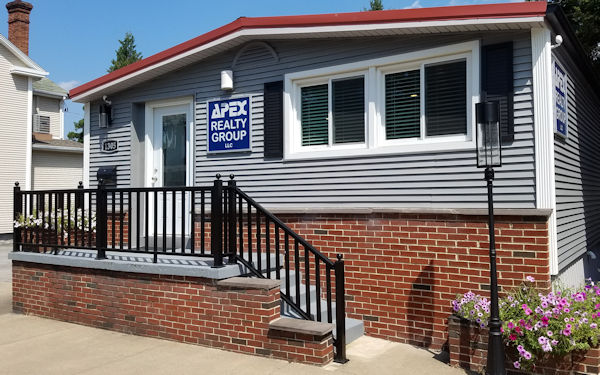 Office with grey siding, sidewalk in front